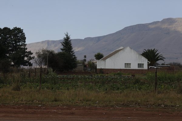 A farmhouse below the mountains